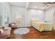 Bedroom featuring a bed, a window with blinds, and a circular patterned rug at 7410 Ambleside Dr, Land O Lakes, FL 34637