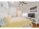 Bright bedroom features a bed, a window with blinds, and a mounted TV on the wall at 7410 Ambleside Dr, Land O Lakes, FL 34637