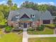 Beautiful clubhouse with stone accents, landscaping, and manicured lawn at 7410 Ambleside Dr, Land O Lakes, FL 34637
