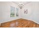 Bright dining room with hardwood floors, a decorative chandelier and large windows at 7410 Ambleside Dr, Land O Lakes, FL 34637