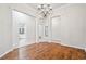 Dining room with wood flooring, white trim and elegant chandelier at 7410 Ambleside Dr, Land O Lakes, FL 34637