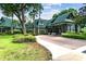 Beautiful building exterior with lush landscaping, stone accents, and covered entrance at 7410 Ambleside Dr, Land O Lakes, FL 34637