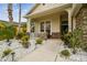 Inviting covered front porch with stone accents, decorative white rocks and solar lighting on a single Gathering home at 7410 Ambleside Dr, Land O Lakes, FL 34637
