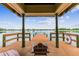 Covered gazebo on a wooden pier overlooking serene water, inviting relaxation at 7410 Ambleside Dr, Land O Lakes, FL 34637