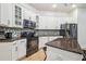 Kitchen with white cabinets, granite countertops and stainless steel appliances at 7410 Ambleside Dr, Land O Lakes, FL 34637