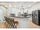 Bright kitchen features white cabinets, granite counters, stainless steel appliances, and a breakfast bar at 7410 Ambleside Dr, Land O Lakes, FL 34637