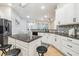 White kitchen featuring dark granite countertops, modern appliances, and a view into the breakfast nook at 7410 Ambleside Dr, Land O Lakes, FL 34637