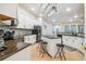 Open kitchen featuring white cabinetry, granite countertops and a kitchen island with seating at 7410 Ambleside Dr, Land O Lakes, FL 34637