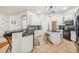 Bright kitchen features white cabinets, granite counters, stainless steel appliances, and a center island at 7410 Ambleside Dr, Land O Lakes, FL 34637