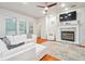 Bright living room with a white sofa, fireplace, and wood floors at 7410 Ambleside Dr, Land O Lakes, FL 34637