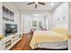 Bright main bedroom features hardwood floors, sitting area, and modern furniture at 7410 Ambleside Dr, Land O Lakes, FL 34637