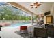 A screened patio offers a pool, a spa, an outdoor bar and multiple seating arrangements for relaxing and entertaining at 7410 Ambleside Dr, Land O Lakes, FL 34637