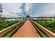 Picturesque wooden pier extending into a tranquil lake under a cloudy sky at 7410 Ambleside Dr, Land O Lakes, FL 34637