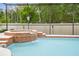 A blue pool and brick hot tub offer relaxation and recreation for Gathering and guests at 7410 Ambleside Dr, Land O Lakes, FL 34637