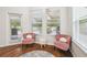 Sitting area features two chairs, a rug, and a window with a view of the screened in pool at 7410 Ambleside Dr, Land O Lakes, FL 34637