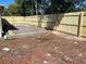 Large backyard featuring a newly constructed fence and an outdoor deck, ready for landscaping at 7415 San Moritz Dr, Port Richey, FL 34668