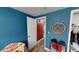 Bright bedroom with blue walls, wood-look flooring and closet at 7415 San Moritz Dr, Port Richey, FL 34668