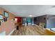View of large living room with hardwood floors, TV, and artwork at 7415 San Moritz Dr, Port Richey, FL 34668