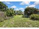 Lush backyard with mature trees, plenty of green space, and some garden features at 7924 Singing Court Pl, Tampa, FL 33615
