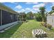 Well-kept backyard with lush lawn, shed for storage, an outdoor swing, and mature trees at 7924 Singing Court Pl, Tampa, FL 33615