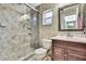 Bathroom featuring a tiled shower with glass doors, updated vanity and tile floors at 7924 Singing Court Pl, Tampa, FL 33615
