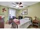 Bedroom with a ceiling fan, desk, bed, nightstand and ample natural light at 7924 Singing Court Pl, Tampa, FL 33615