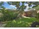 Inviting front yard with lush landscaping and charming seating area at 7924 Singing Court Pl, Tampa, FL 33615