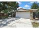 Spacious garage with stone accents and ample parking on a sunny day at 7924 Singing Court Pl, Tampa, FL 33615