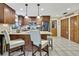 Updated kitchen with wood cabinets, stainless steel appliances, and island with seating at 7924 Singing Court Pl, Tampa, FL 33615