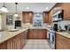 This is a kitchen with stainless steel appliances, wood cabinets and tile backsplash at 7924 Singing Court Pl, Tampa, FL 33615