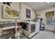 Bright laundry room with modern washer and dryer, useful folding rack, and ample storage space at 7924 Singing Court Pl, Tampa, FL 33615