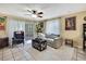 Cozy living room features tile floors, ceiling fan, comfortable seating and natural light at 7924 Singing Court Pl, Tampa, FL 33615