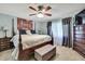 Cozy bedroom with a king-size bed, ceiling fan, and decorative wall art at 7924 Singing Court Pl, Tampa, FL 33615