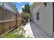 Side yard features a stone paver pathway, privacy fence, and garden area at 7924 Singing Court Pl, Tampa, FL 33615