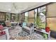 Cozy sunroom with tiled floor, ceiling fan, comfortable seating, and abundant natural light at 7924 Singing Court Pl, Tampa, FL 33615