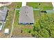 Aerial view of a house with a fenced yard, surrounded by lush trees at 8508 Bay Dr, Spring Hill, FL 34606