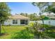 Lush backyard with a privacy fence and a screened lanai at 8508 Bay Dr, Spring Hill, FL 34606