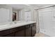 Bathroom with double sinks, vanity, framed mirror, and a separate stand-up shower at 8508 Bay Dr, Spring Hill, FL 34606