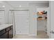 Bathroom features a shower and an attached closet with shelving at 8508 Bay Dr, Spring Hill, FL 34606
