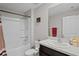 Bright bathroom featuring a shower-tub combo, sleek vanity with sink, and modern fixtures, providing comfort and style at 8508 Bay Dr, Spring Hill, FL 34606