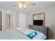 Inviting bedroom with ceiling fan, dresser, and comfortable bed, creating a relaxing and stylish space at 8508 Bay Dr, Spring Hill, FL 34606