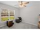Bright bedroom with a ceiling fan and large window, perfect for a home office or study space at 8508 Bay Dr, Spring Hill, FL 34606