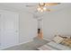 Bedroom with ceiling fan, soft carpet, neutral walls, and natural light, creating a comfortable, serene space at 8508 Bay Dr, Spring Hill, FL 34606