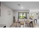 Dining area with a wood table and a sliding glass door overlooking the back yard at 8508 Bay Dr, Spring Hill, FL 34606