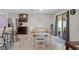 Dining area with an island bar, modern decor, and sliding door access to the backyard at 8508 Bay Dr, Spring Hill, FL 34606