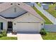 Features a well-manicured lawn and a two-car garage at 8508 Bay Dr, Spring Hill, FL 34606