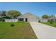 Beautiful single-story home with a white picket fence, manicured lawn, and a welcoming two-car garage at 8508 Bay Dr, Spring Hill, FL 34606