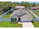 Charming single-story home with a well-manicured lawn, white fence, and attached two-car garage at 8508 Bay Dr, Spring Hill, FL 34606