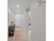 Neutral hallway with tile flooring, decorated with wall art and leading to the front door and living area at 8508 Bay Dr, Spring Hill, FL 34606
