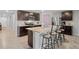 Modern kitchen featuring stainless steel appliances, dark wood cabinets, and a large island with bar seating at 8508 Bay Dr, Spring Hill, FL 34606
